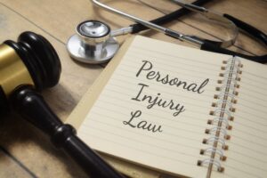 The phrase Personal Injury Law is displayed alongside a gavel and a stethoscope, symbolizing the intersection of law and healthcare in addressing injury claims.