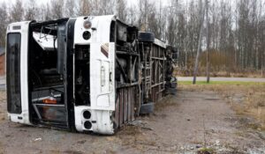 The image depicting a broken semi-truck lying on its side after an accident, capturing the aftermath with debris and a realistic highway scene. 