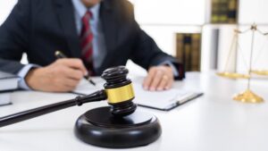 Lawyer consulting or negotiating a legal case with women entrepreneurs, discussing contracts and documents in an office setting.