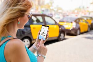 A woman using a ride-sharing app on her mobile phone. 